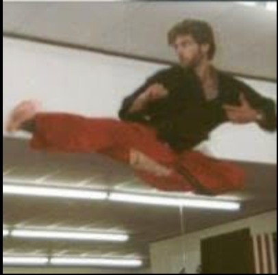 Stephen Oliver in mid-air performing a flying side kick at Mile High Karate in Lakewood, Colorado, 1983